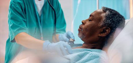 Man in hospital bed receiving treatment